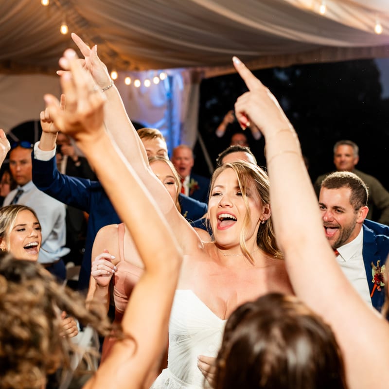 Wedding guests dancing celebration tent party