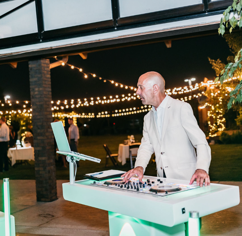 DJ performing outdoor evening wedding reception
