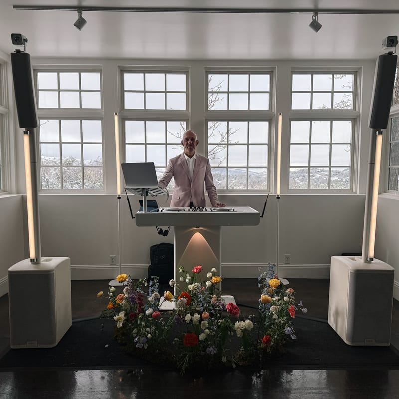 Man performing at keyboard with flowers