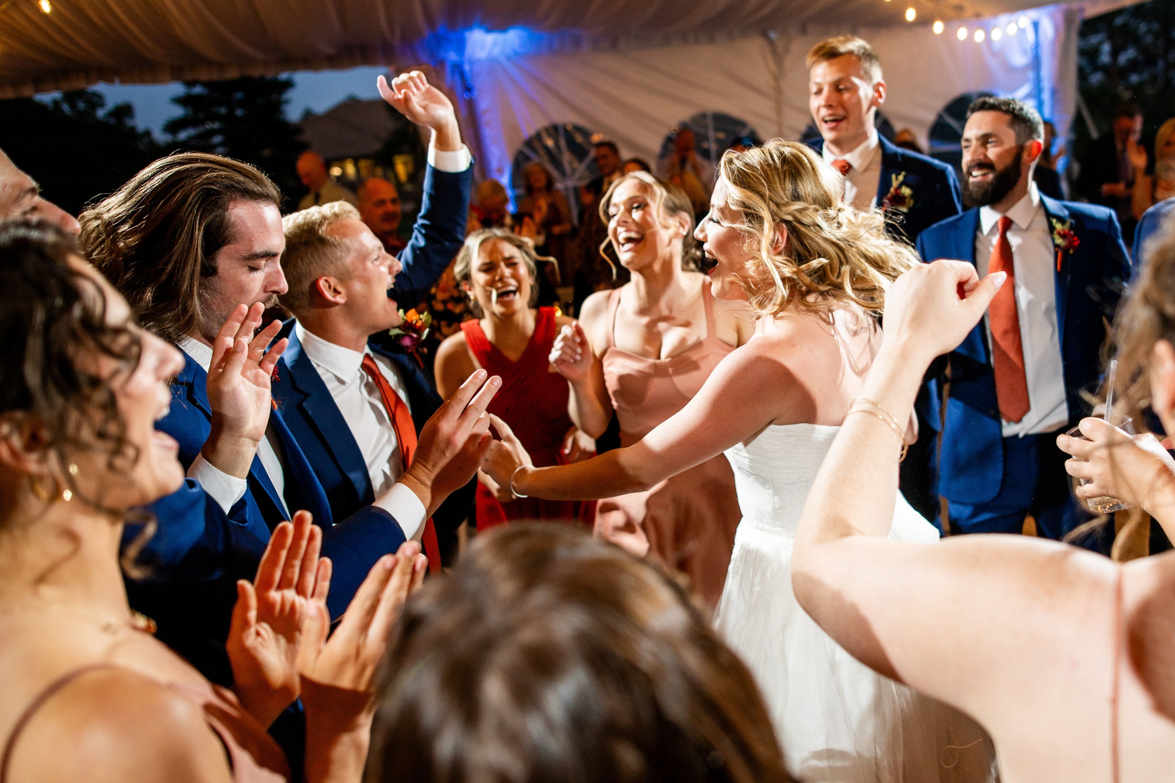 Bride dancing with guests at wedding reception