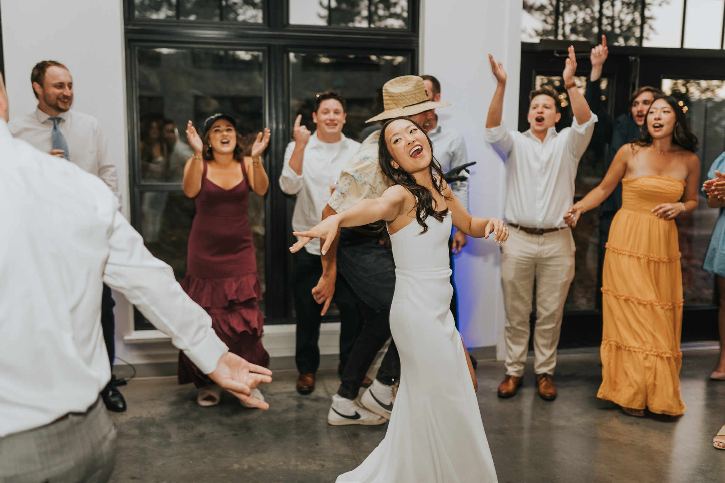 Bride dancing with guests at wedding reception